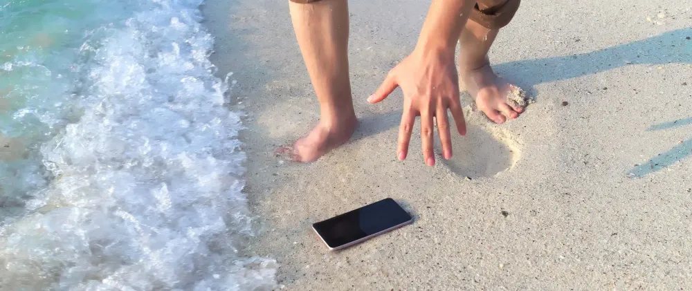 Beach Reaching for Phone